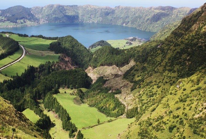 Lake in a volcanic crater surrounded by green mountains