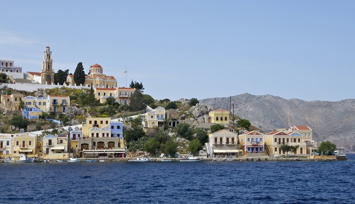Colorful houses on a hillside in Ano Symi, Greece