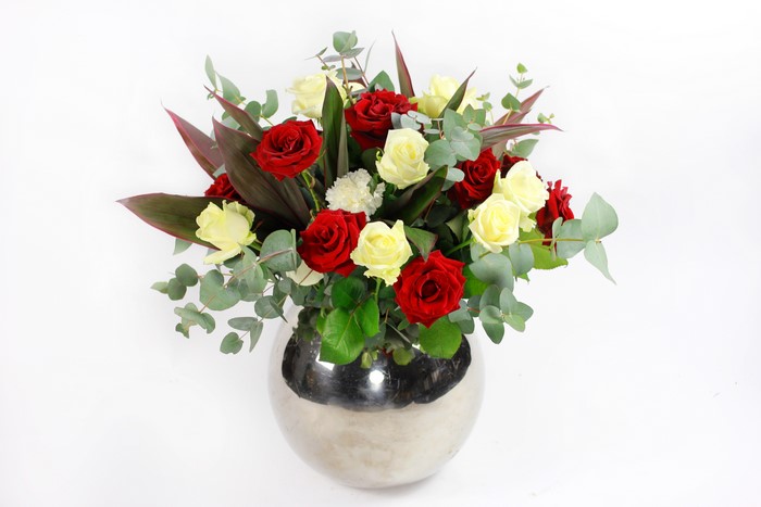 Red and yellow roses in a silver vase
