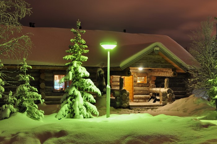 Log cabin in Finland at night during winter