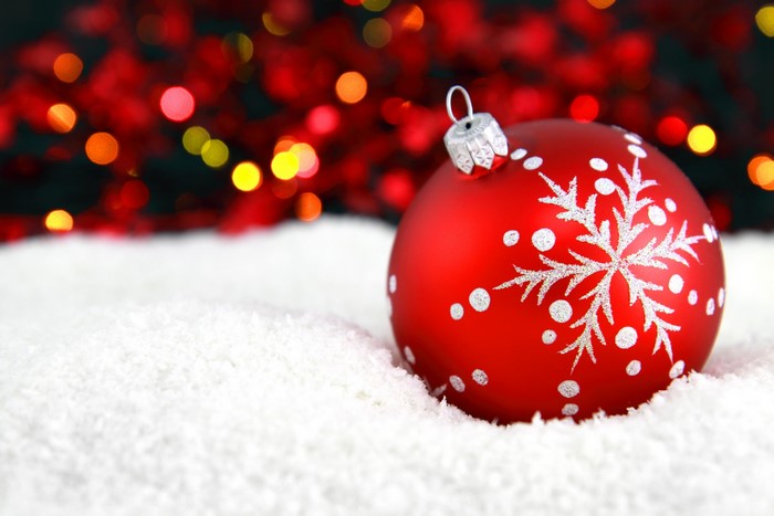 Red Christmas ornament with snowflake in snow