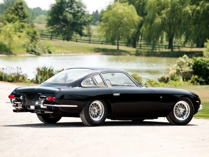 Black Lamborghini 350 GT parked by a lake