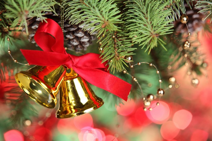 Christmas Bells with Red Ribbon on Pine Branches