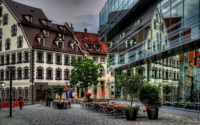 Street cafe in front of historic and modern buildings in Germany