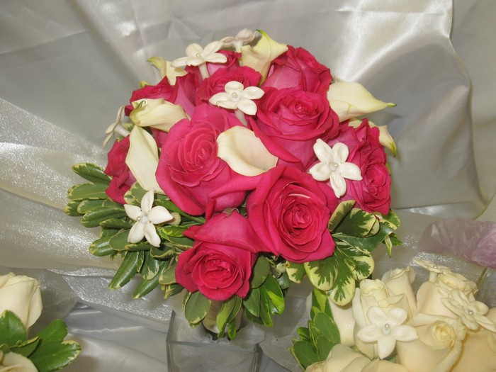 Pink and white rose bouquets with greenery