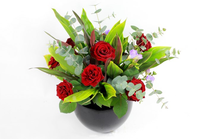 Red Roses and Greenery in a Black Vase