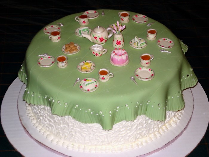 Tea party cake with miniature tea set and cake
