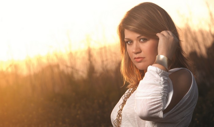 Kelly Clarkson in white top with golden hour lighting