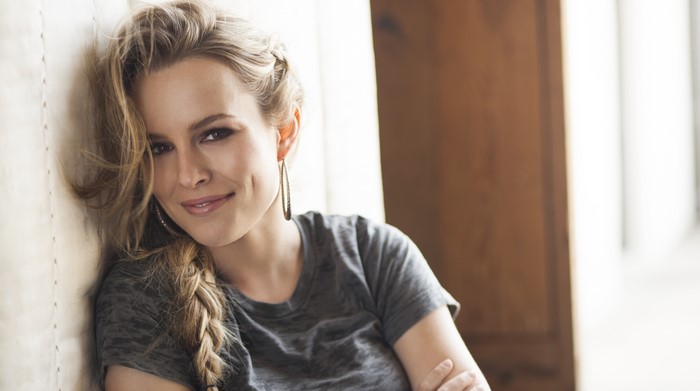 Bridgit Mendler leaning against a wall