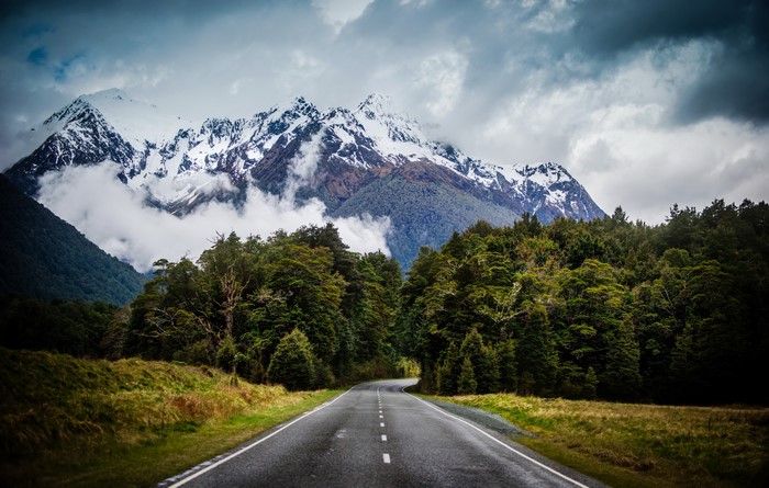 Road leading to snow-capped mountains in New Zealand