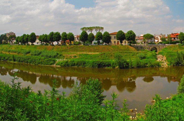 River with trees and buildings in Italy