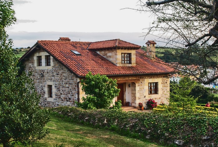 Stone house with red tile roof in Spain