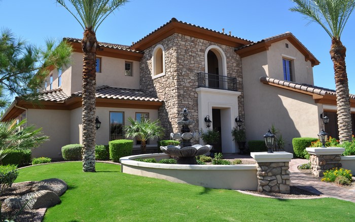 Luxury mansion with stone facade and fountain