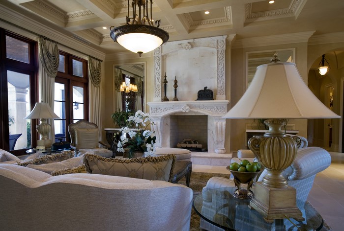 Living room with fireplace, chandelier, and lamps