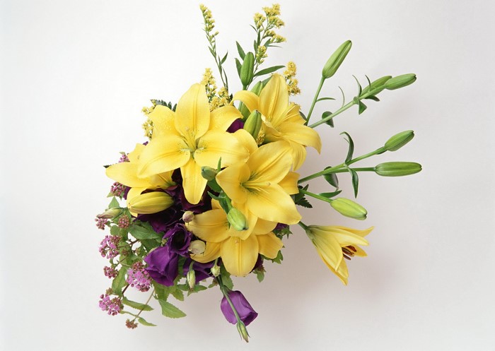 Yellow lilies and purple flowers bouquet