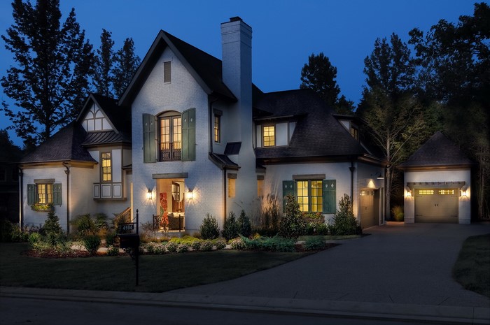 Luxury brick house with garage at night