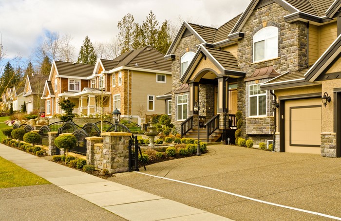 Luxury houses with stone facades and manicured lawns