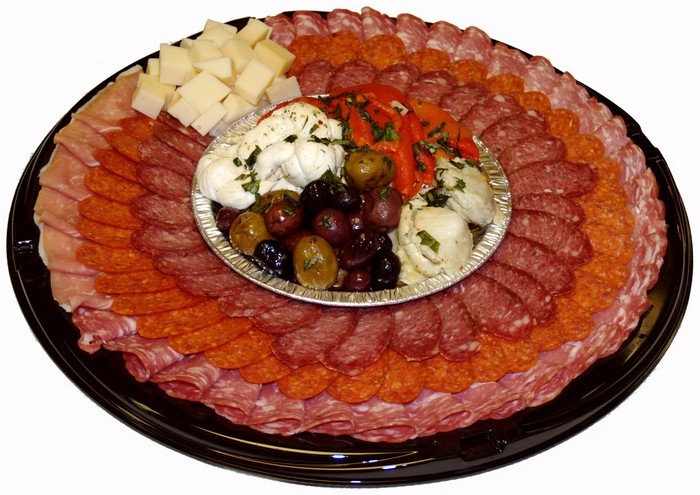 Charcuterie board with meats, cheese, olives, and peppers