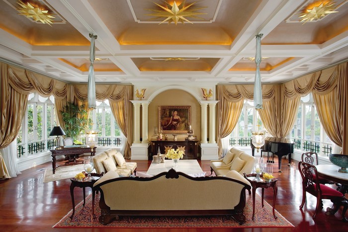 Luxurious living room with ornate ceiling and furniture