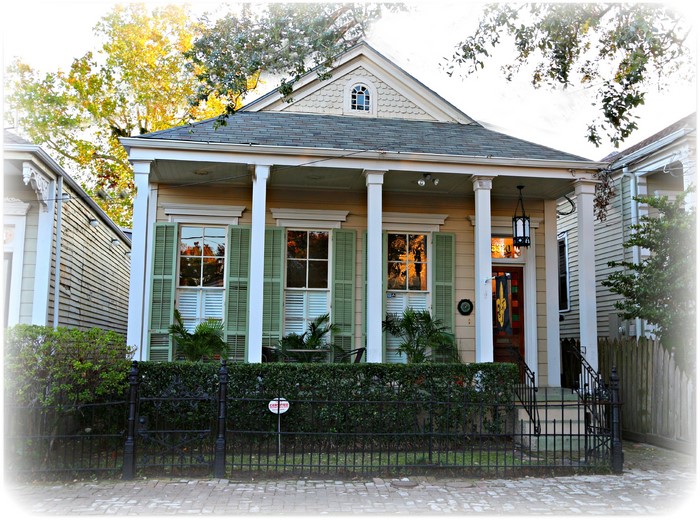 New Orleans house with green shutters and columns