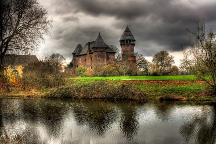 Krefeld Burg Linn castle with river and clouds