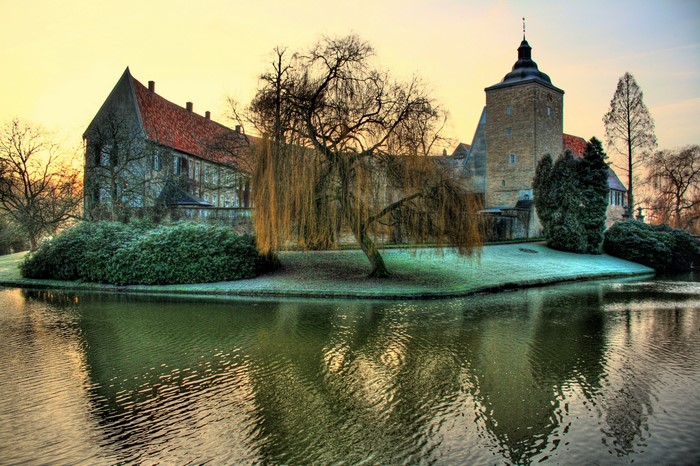 Castle Steinfurt with moat and weeping willow tree