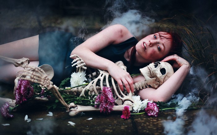 Redhead girl with skeleton and flowers
