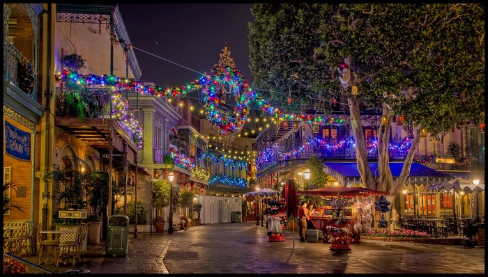 Disneyland street decorated with Christmas lights at night