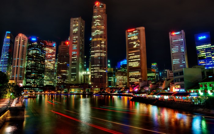 Singapore skyscrapers at night with river reflections