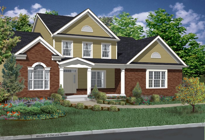 Two-story brick and siding house with landscaping