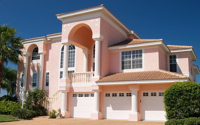 Pink Mediterranean Mansion with Arches and Garages