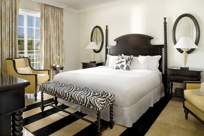 Bedroom with four-poster bed and zebra bench