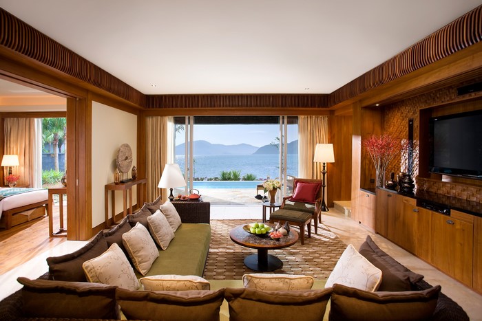 Living room with a view of the ocean and a swimming pool