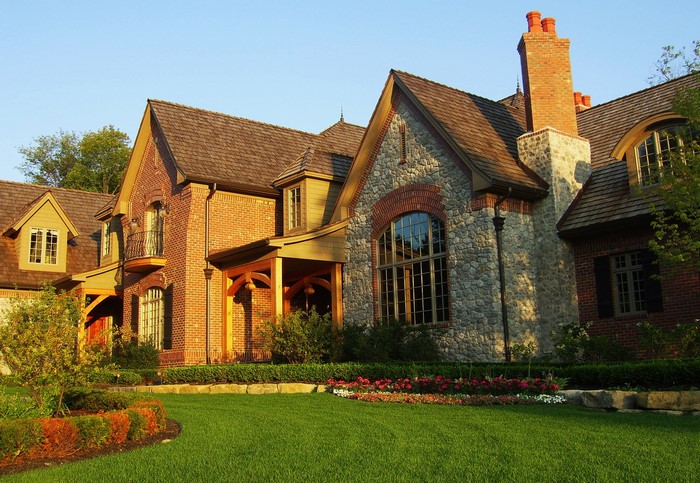 Luxury brick and stone house with manicured lawn