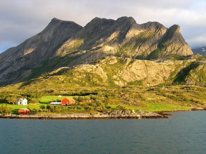 Red and white houses by a mountain and the sea