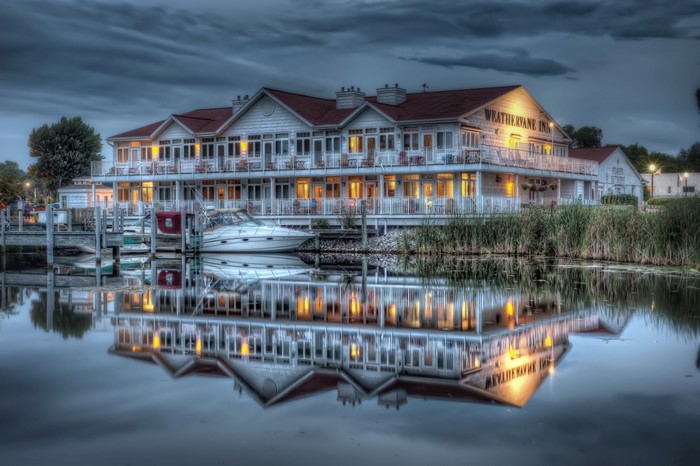 Weather vane Inn hotel on a lake with boats