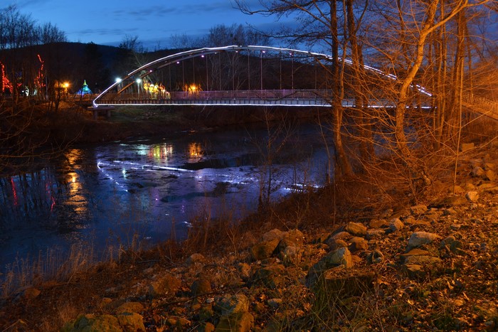 Bridge over river at night with lights