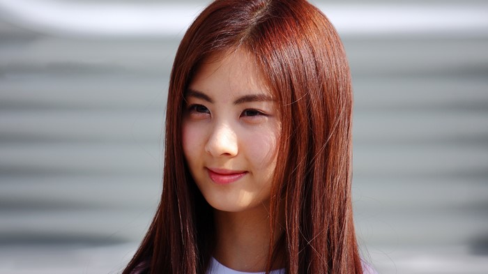 Asian girl with red hair glancing sideways