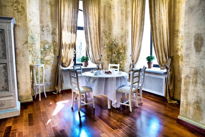 Dining room with table, chairs, and floral wallpaper