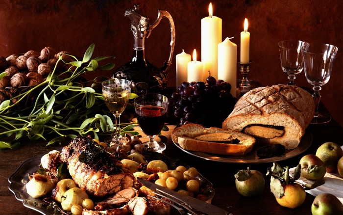 Still-life with roast, bread, wine, and candles