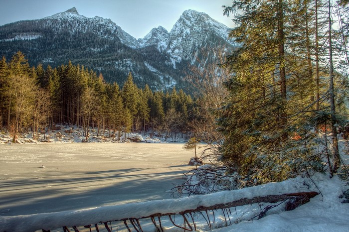 Winter scene with snow-covered mountains and frozen lake