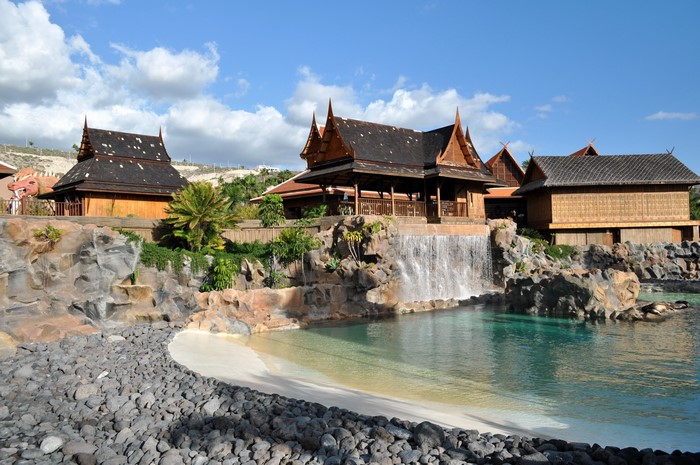 Thai-style buildings with waterfall and pool in Spain