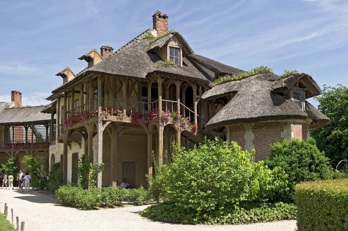 Thatched roof houses with wooden balconies in France