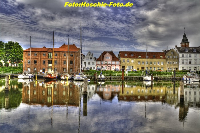 Boats docked in a German harbor with colorful buildings