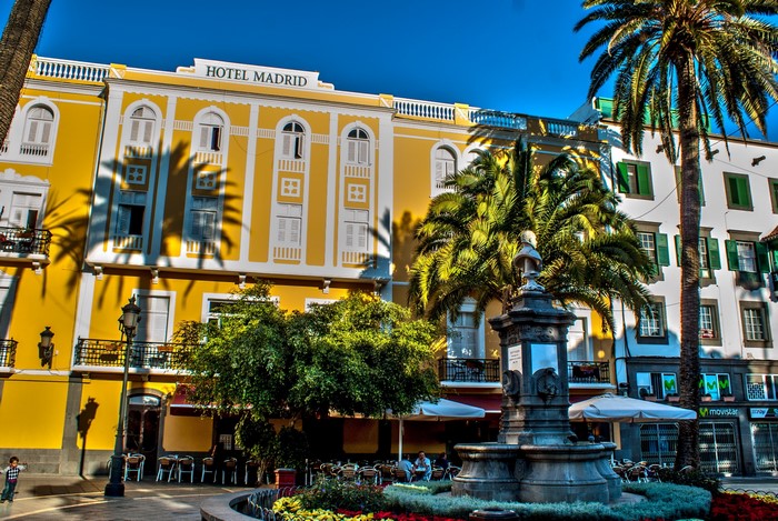 Hotel Madrid building with fountain and palm trees