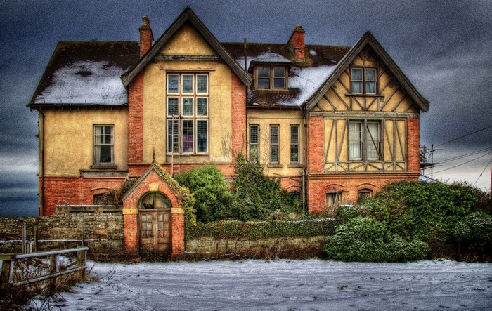 Old brick and stucco house with snow