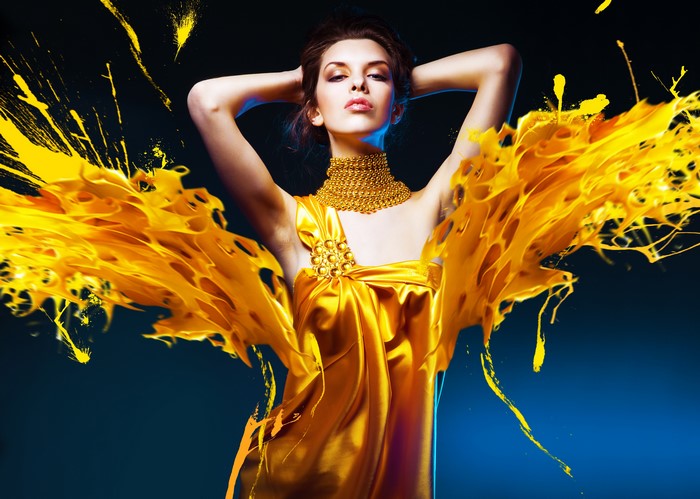 Brunette girl in gold dress with yellow splashes