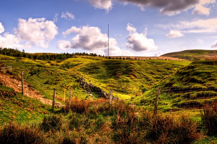 Rolling green hills with a tall tower in England