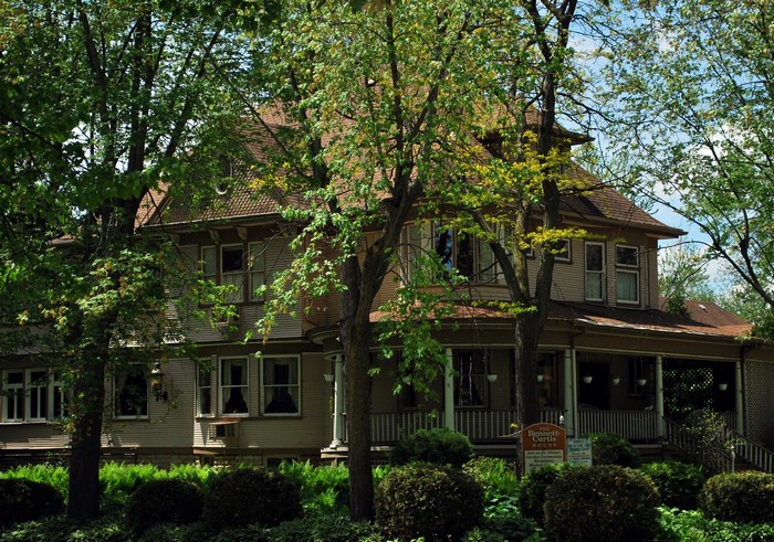 Bennett-Curtis House surrounded by trees and shrubs
