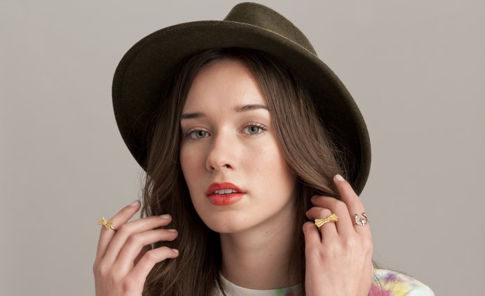Brunette girl wearing a hat and rings